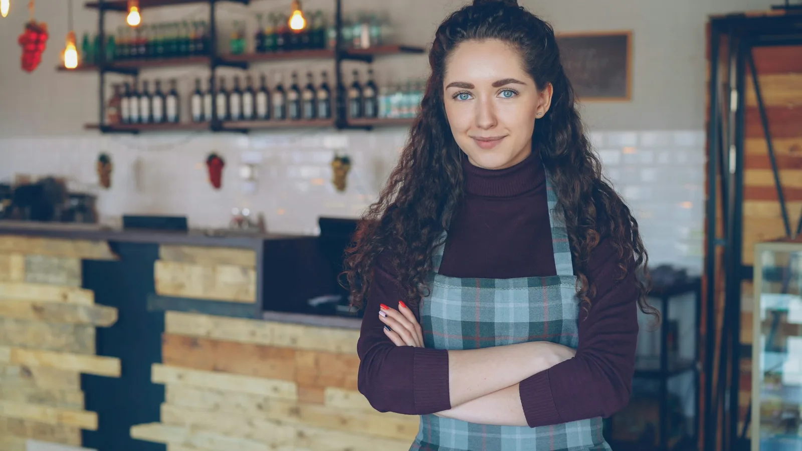 A confident small business owner standing in her shop